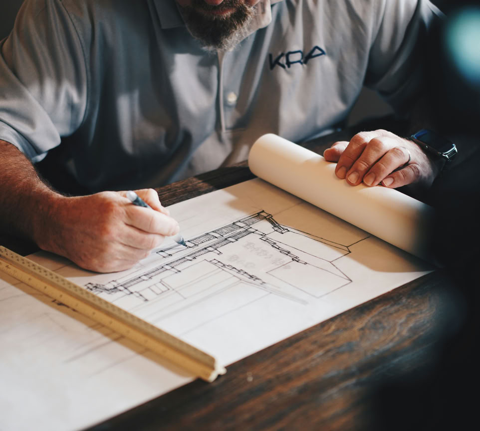 Silhouette of electrician fixing tangled wires on a utility pole in Ubud, Bali at dusk.